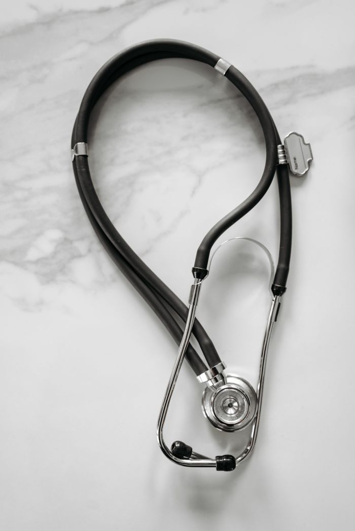 Professional-grade stethoscope on a white marble background, ideal for medical themes.
